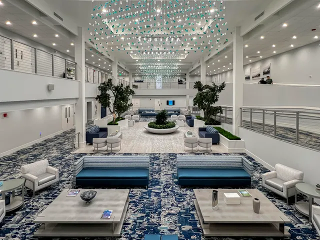 a living room with lots of furniture and a chandelier