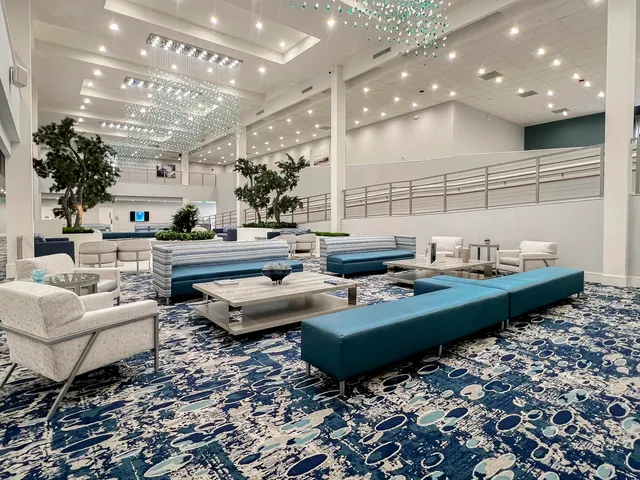 a living room with pool table and chairs