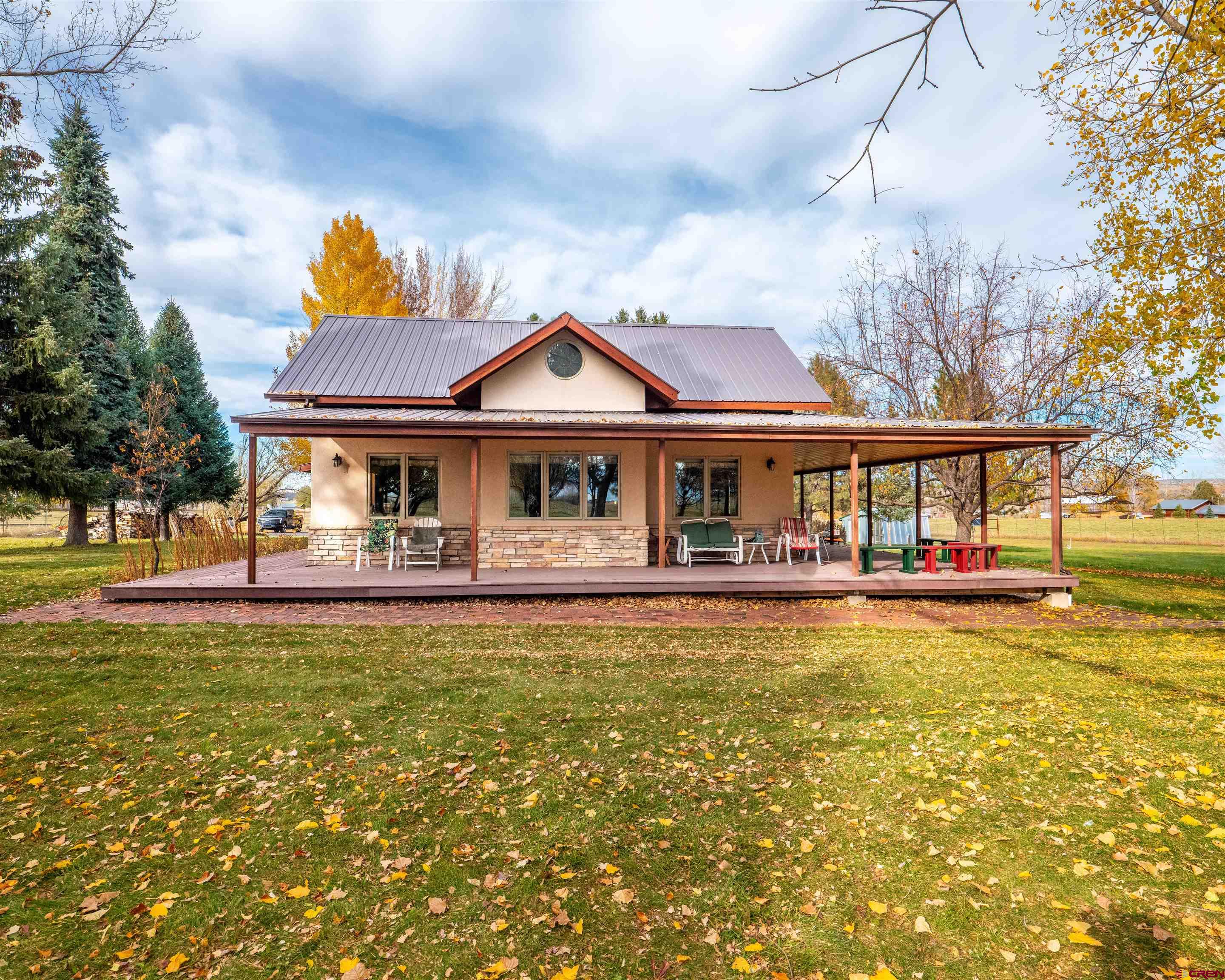 a front view of a house with swimming pool having outdoor seating