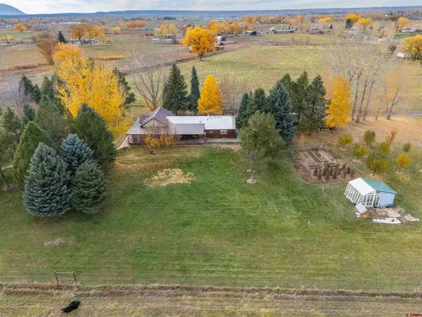 a view of a yard with wooden fence