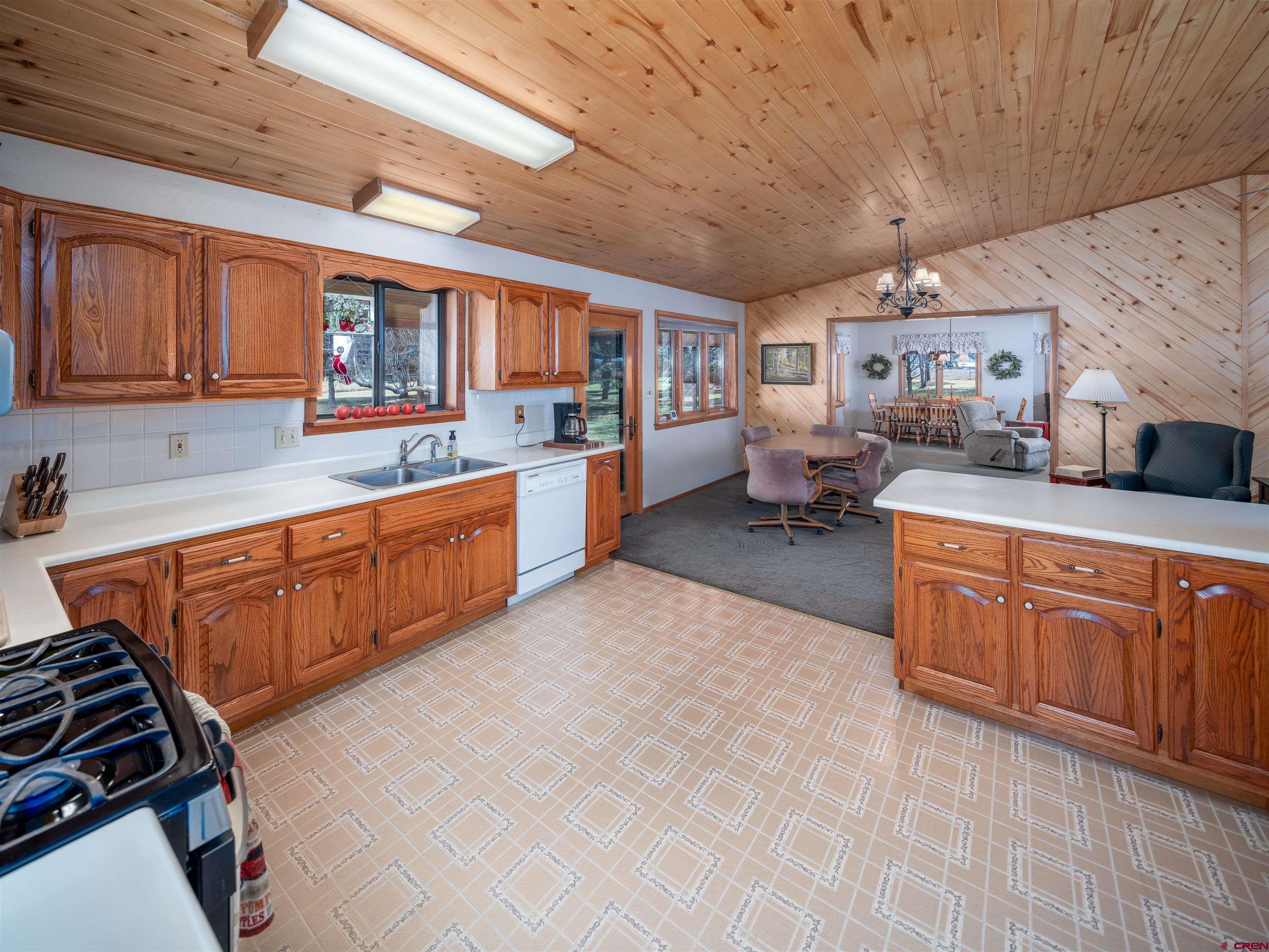 24620 Rd North Cortez, CO 81321 - Photo 22 of 40 a large kitchen with a large stove a sink dishwasher and wooden cabinets