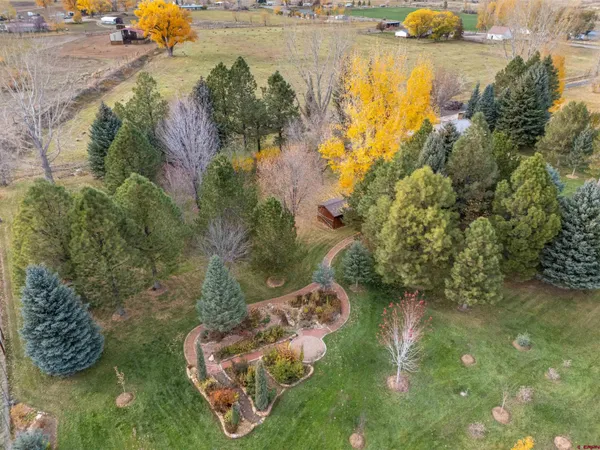an aerial view of residential houses with outdoor space and swimming pool