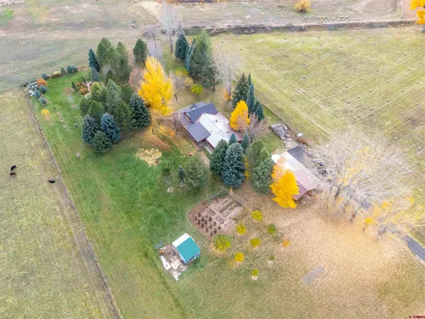 a aerial view of a house with a yard basket ball court and outdoor seating