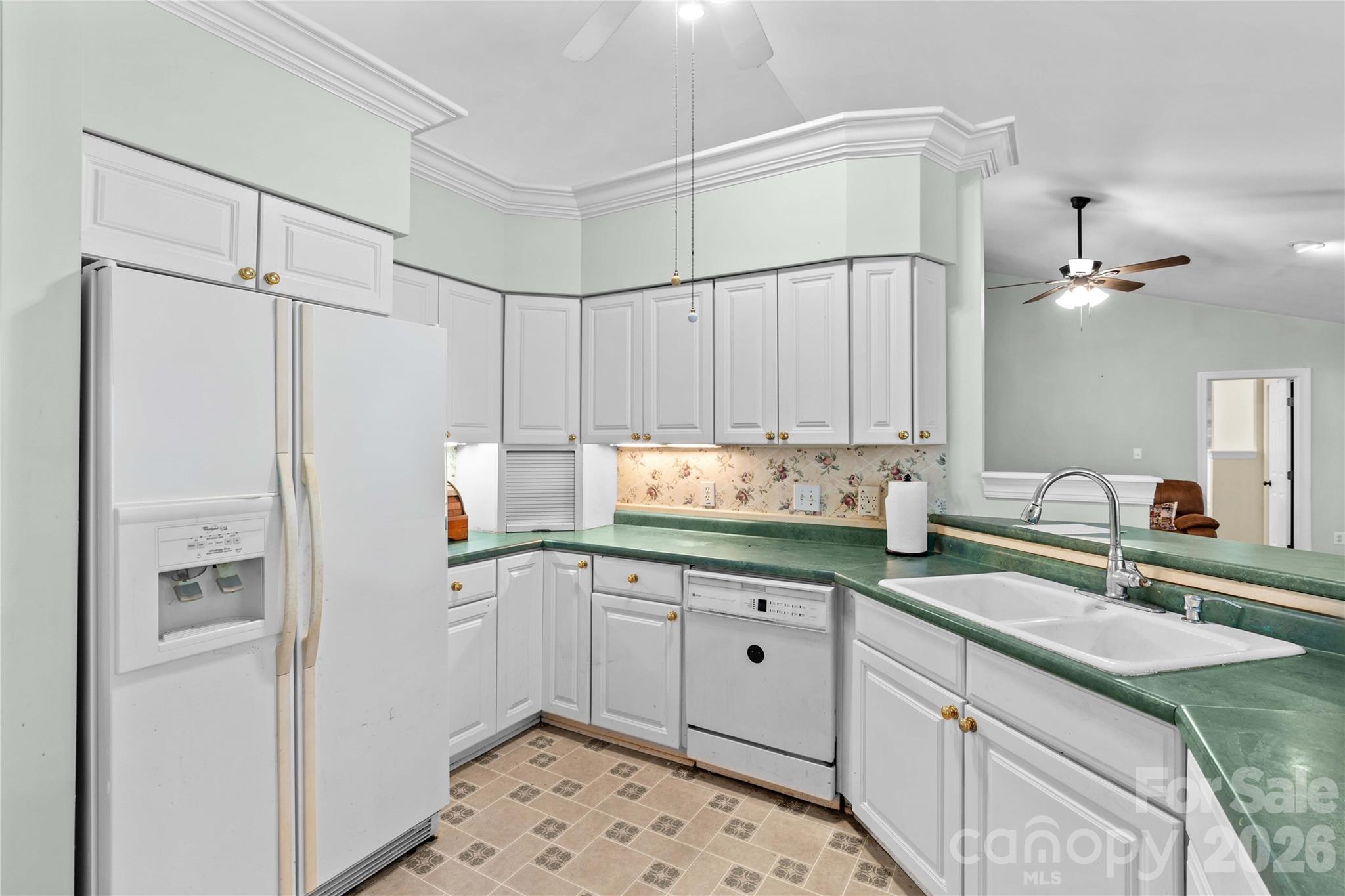 711 Spring Pointe Drive Stony Point, NC 28678 - Photo 16 of 47 a kitchen with granite countertop a sink stainless steel appliances and cabinets