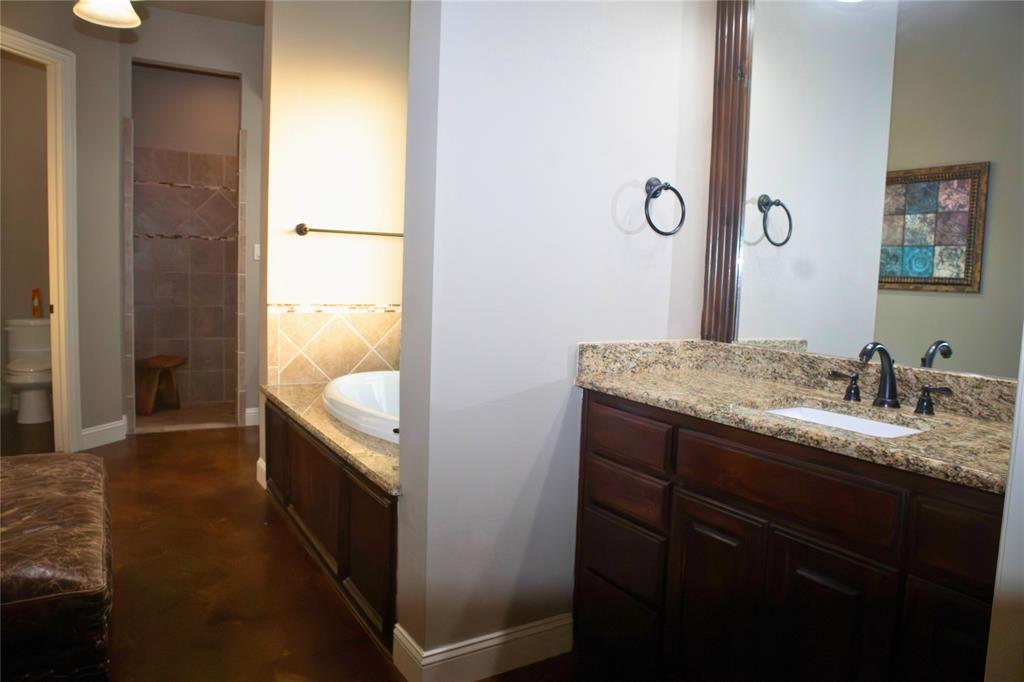 7115 Sussex Lane Mansfield, TX 76063 - Photo 12 of 25 a bathroom with a granite countertop sink and a mirror