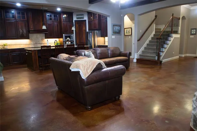 a living room with furniture and a kitchen view