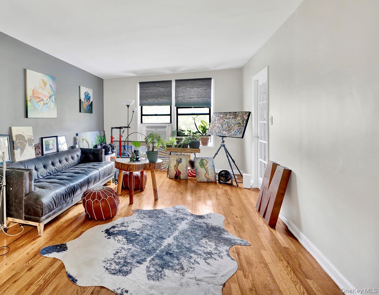Living room featuring light wood-type flooring and baseboards