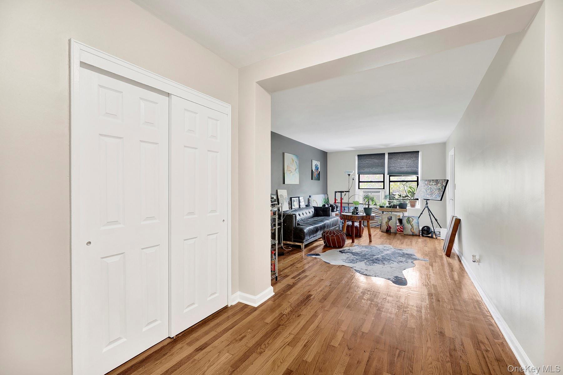 285 East 35th Street, Unit 6E Brooklyn, NY 11203 - Photo 3 of 21 Living room featuring wood finished floors and baseboards