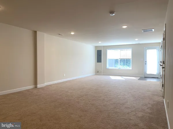 an empty room with windows and closet
