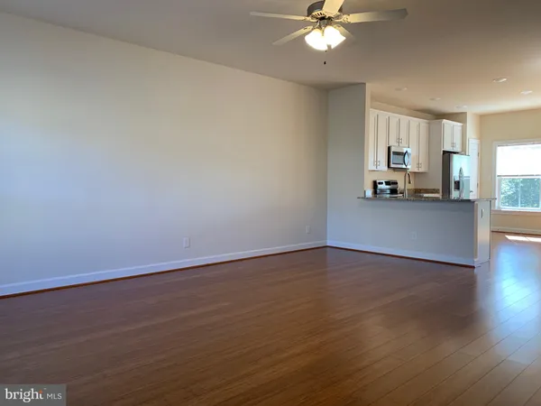 a view of a livingroom with a furniture wooden floor and chandelier
