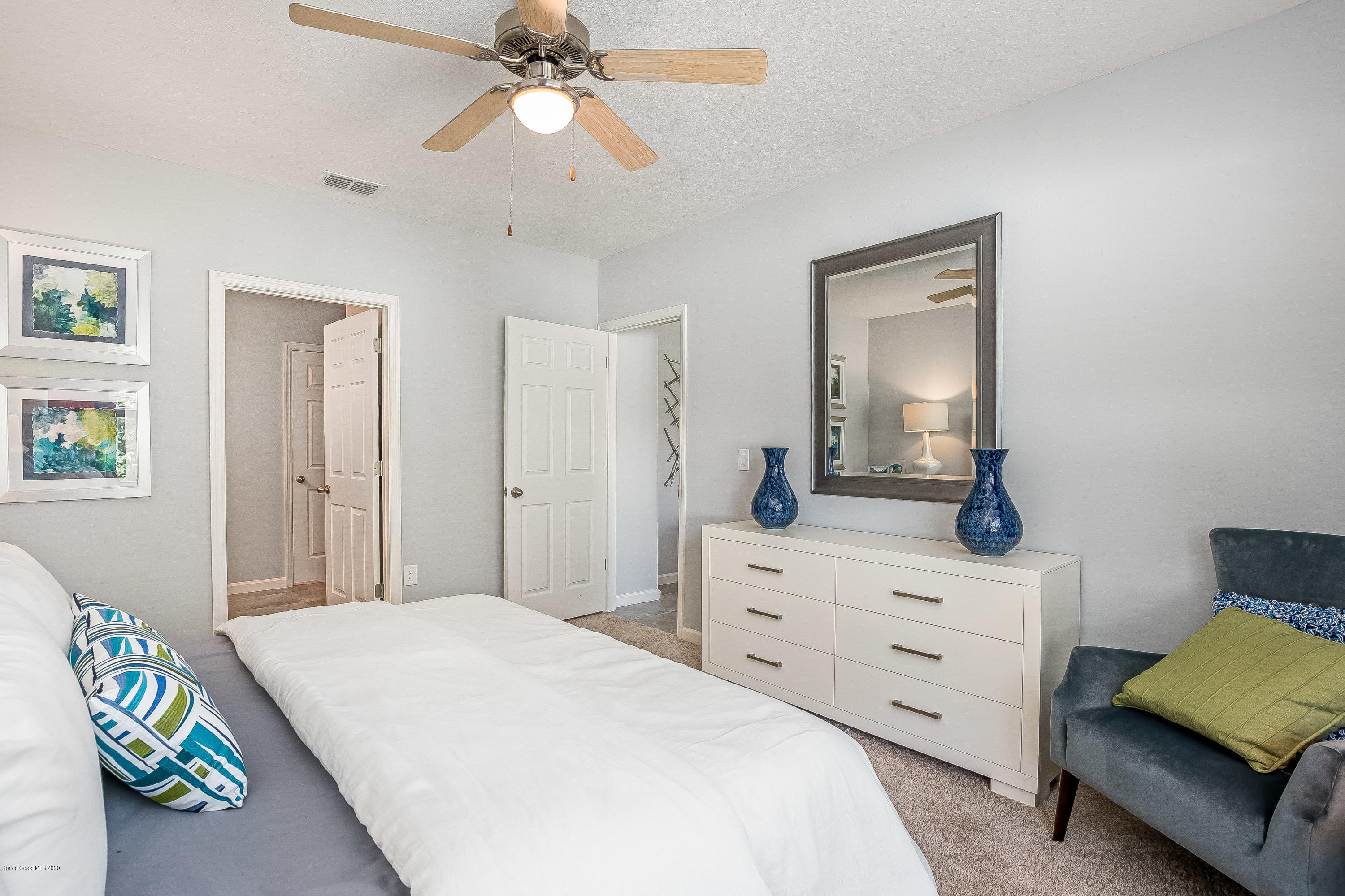 3469 Burrowing Owl Drive Mims, FL 32754 - Photo 11 of 40 a bedroom with a bed and a dresser