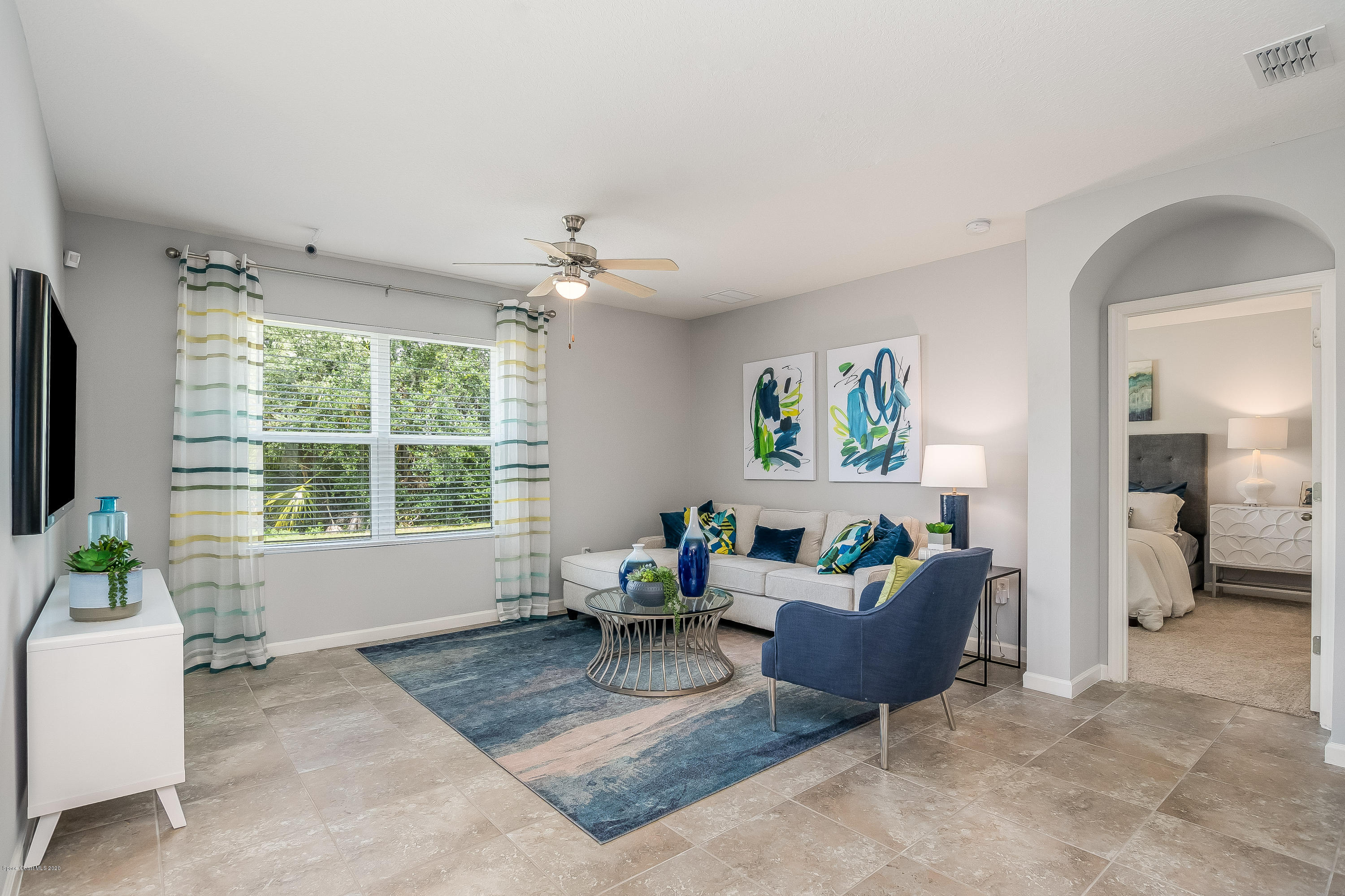 3469 Burrowing Owl Drive Mims, FL 32754 - Photo 7 of 40 a living room with furniture and a large window