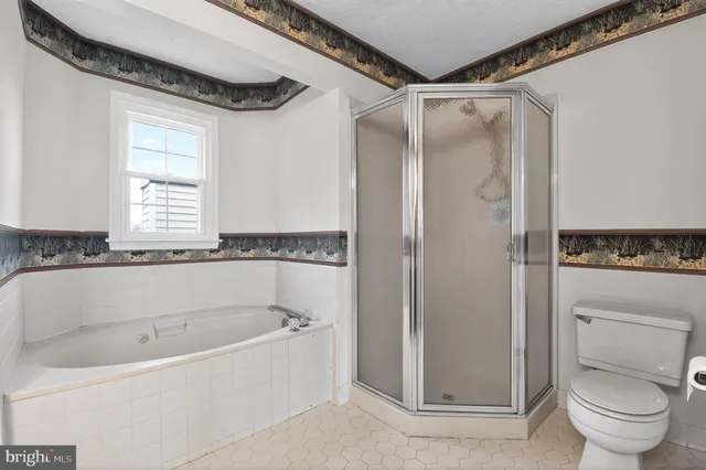 a white bath tub sitting next to a toilet