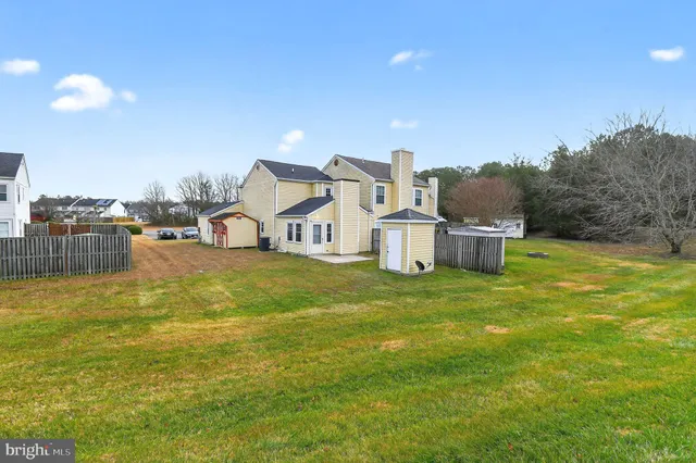 a view of a house with a yard and swimming pool