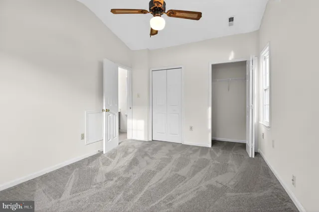 a view of empty room with ceiling fan