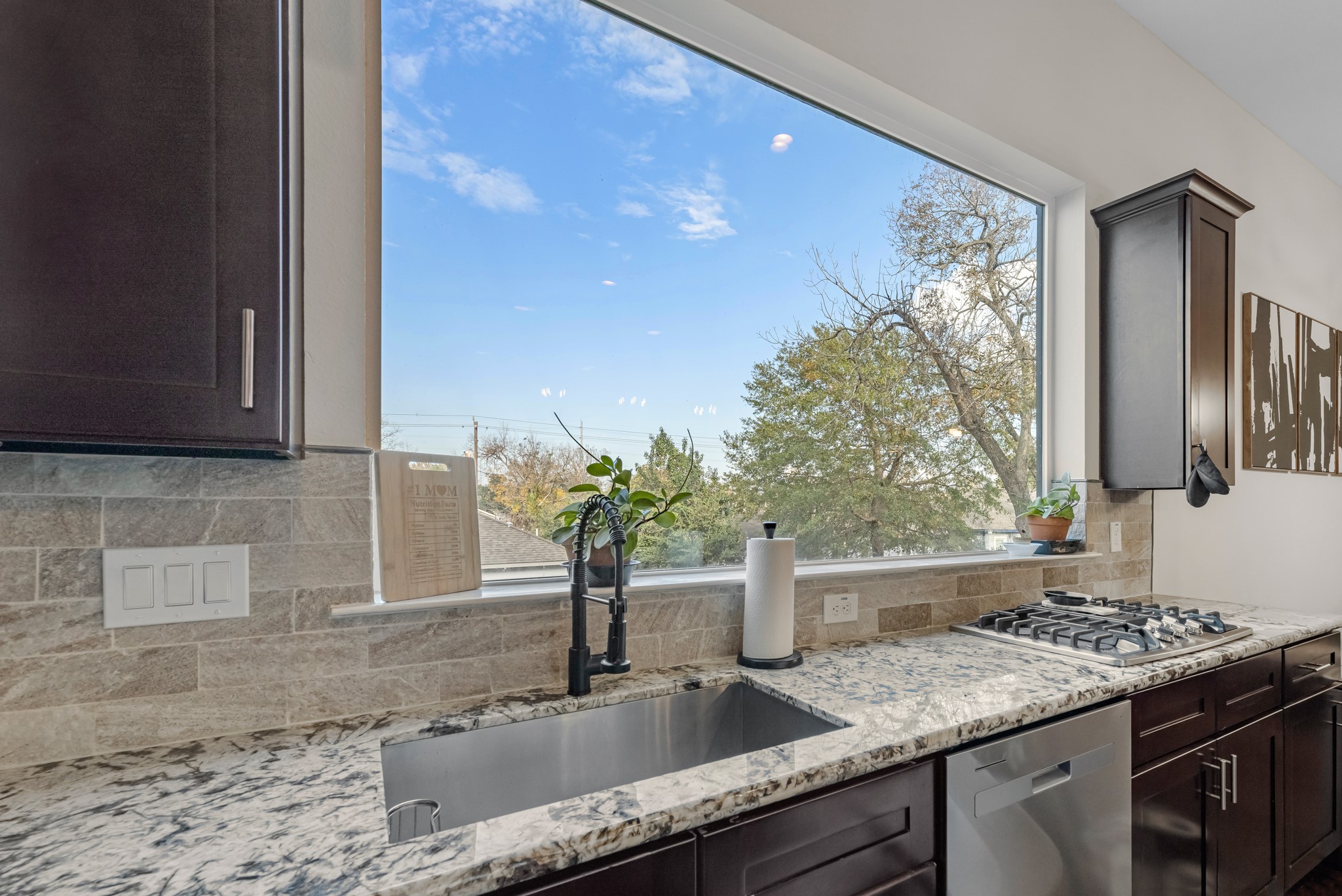209 Burr Street, Unit D Houston, TX 77011 - Photo 11 of 20 a kitchen with granite countertop a sink stainless steel appliances and cabinets