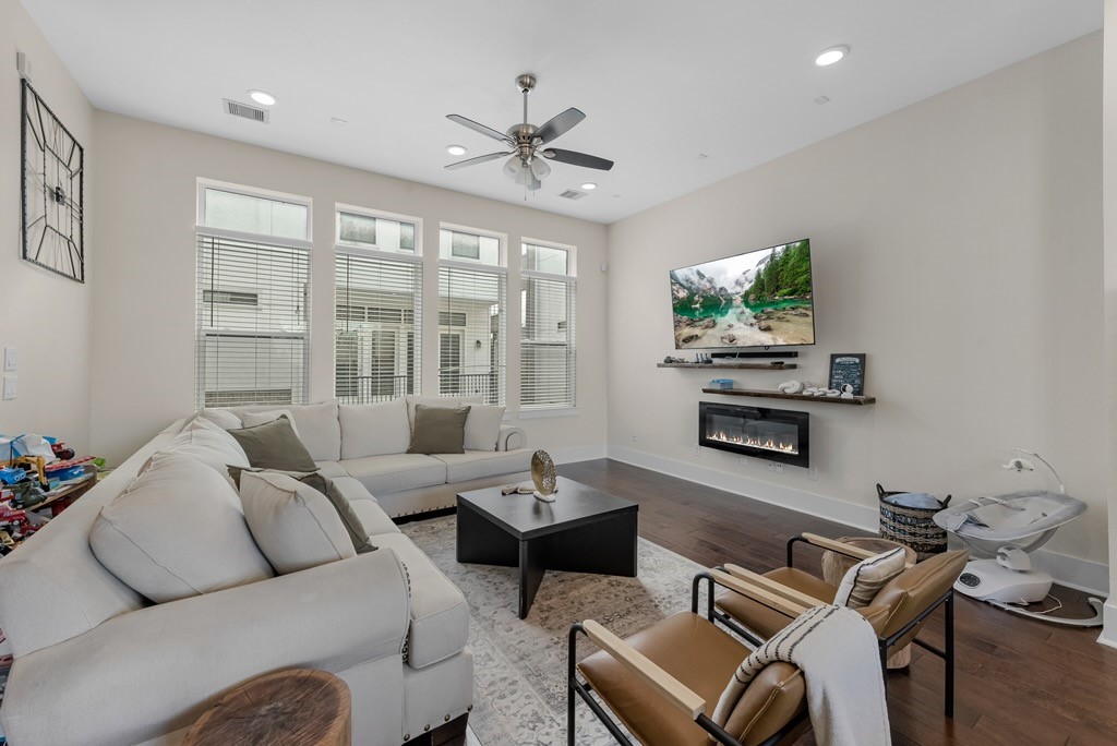 209 Burr Street, Unit D Houston, TX 77011 - Photo 6 of 20 a living room with furniture and a flat screen tv