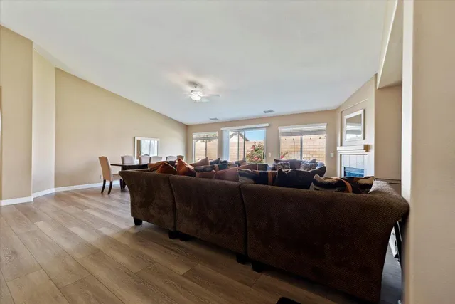 a living room with furniture a wooden floor and a window
