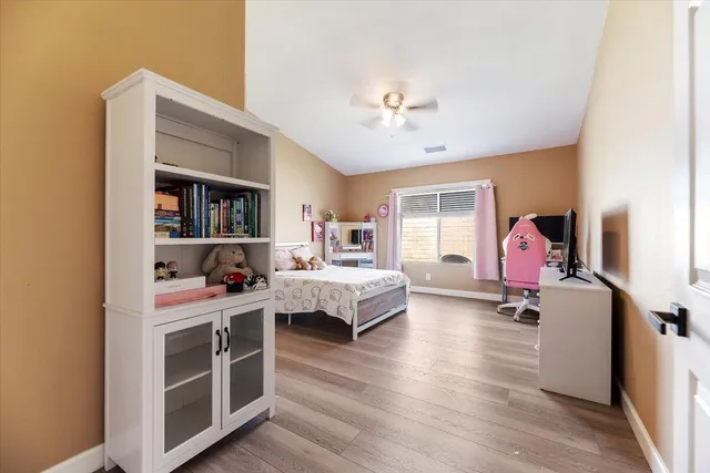 a bedroom with furniture and a book shelf