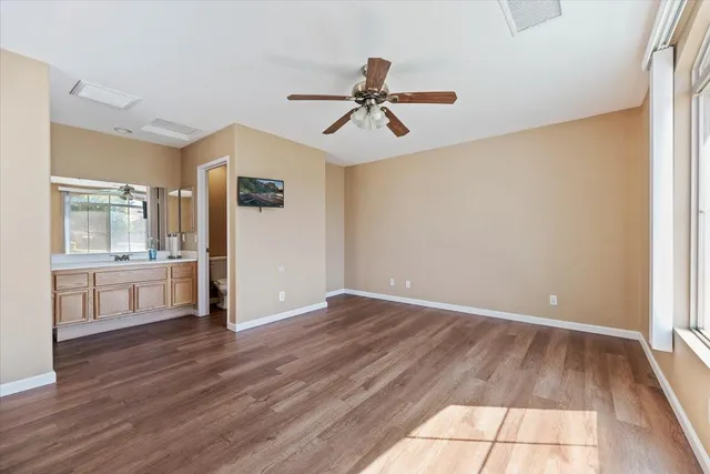 a view of empty room with wooden floor and window