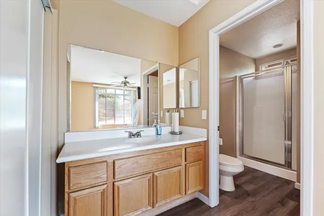 a bathroom with a double vanity sink toilet and a mirror