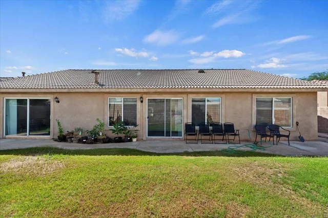 a front view of house with yard and outdoor seating