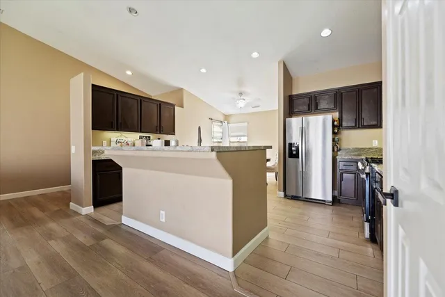 a kitchen with a refrigerator a oven and a sink