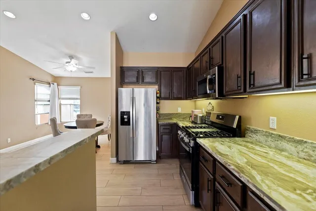 a kitchen with a refrigerator a sink and a stove