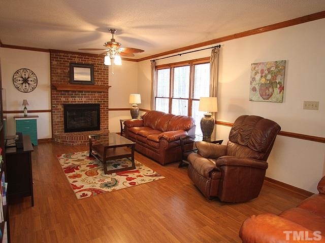 5767 Cornwallis Road Garner, NC 27529 - Photo 4 of 17 Open inviting family room with masonry fireplace that has a unique circular hearth.