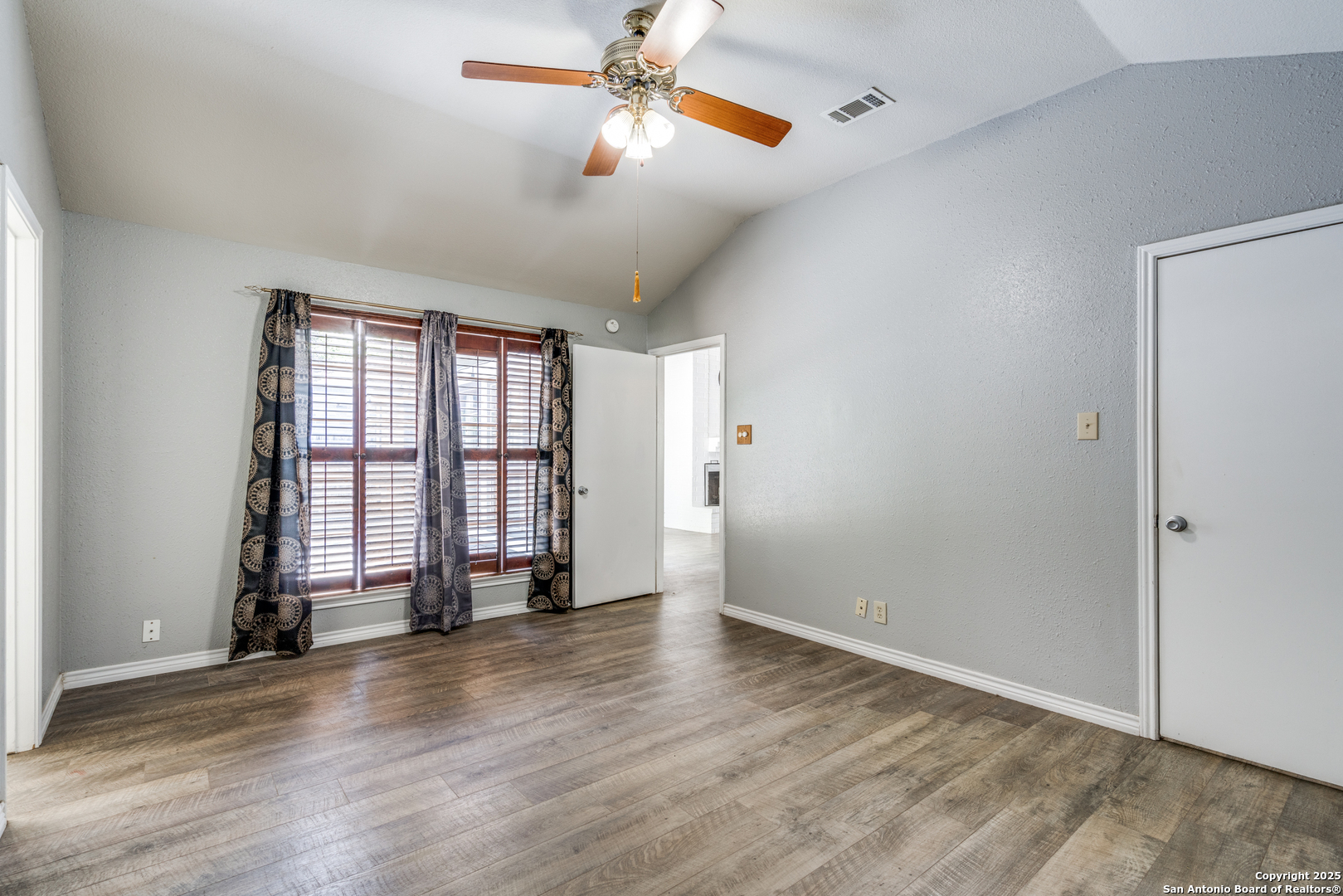 8009 Forest Ash Live Oak, TX 78233 - Photo 17 of 33 an empty room with wooden floor fan and windows