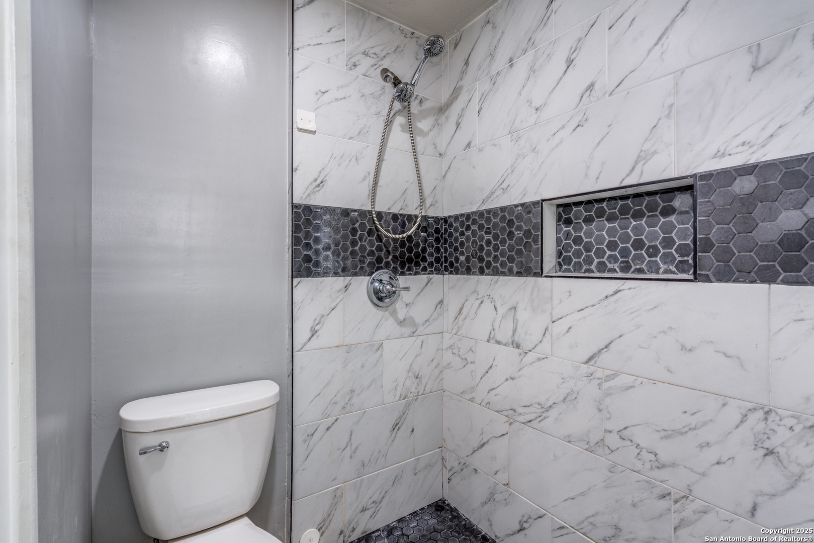8009 Forest Ash Live Oak, TX 78233 - Photo 19 of 33 a bathroom with a toilet and a shower