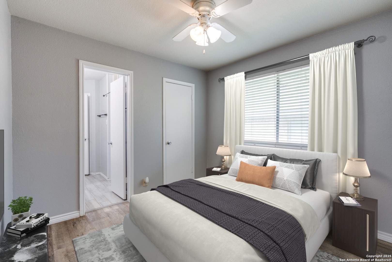 8009 Forest Ash Live Oak, TX 78233 - Photo 24 of 33 a bedroom with a bed and a chandelier