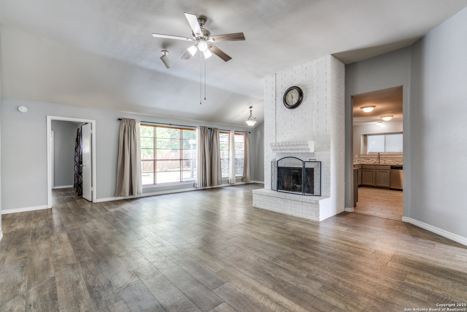8009 Forest Ash Live Oak, TX 78233 - Photo 8 of 33 wooden floor fireplace and windows in an empty room
