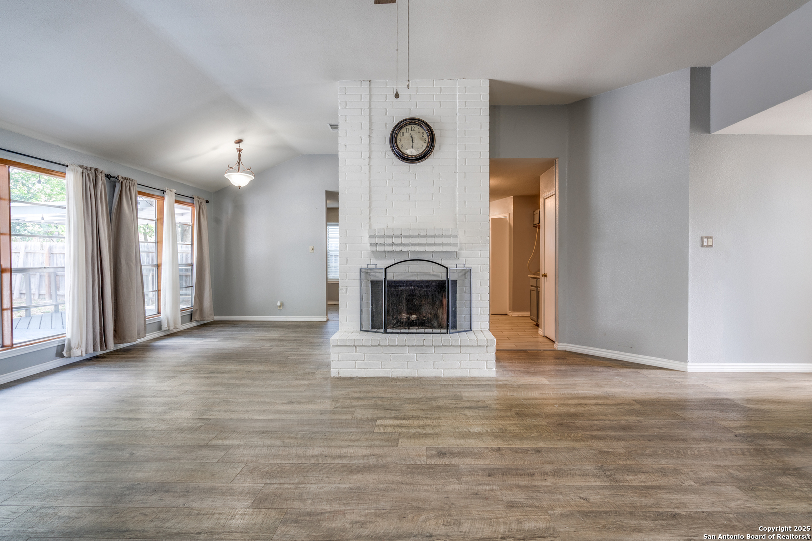 8009 Forest Ash Live Oak, TX 78233 - Photo 9 of 33 a view of an empty room with a fireplace and a window