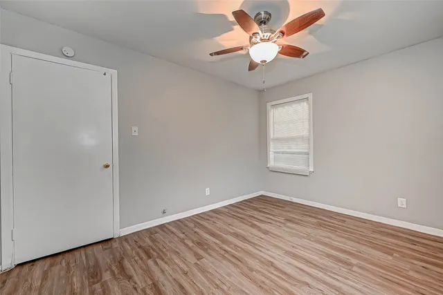 wooden floor in an empty room with a window