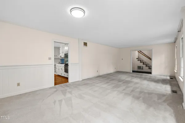 a open kitchen with white cabinets and stainless steel appliances