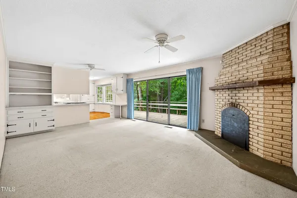 a kitchen with stainless steel appliances kitchen island granite countertop a refrigerator oven a stove with white cabinets