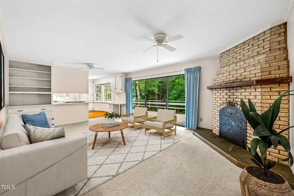 a view of a kitchen with microwave and windows