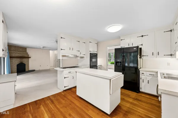 a kitchen with stainless steel appliances a refrigerator and a stove top oven