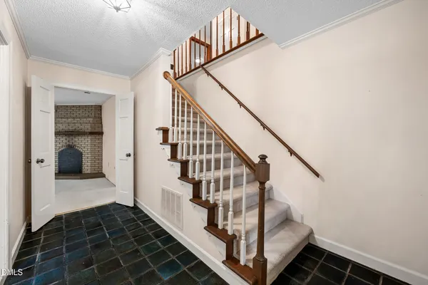 a work room with furniture a flat screen tv and a window