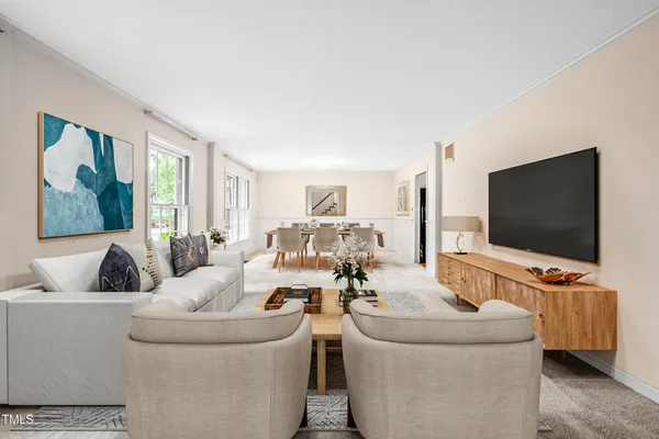 a living room with furniture a fireplace and a table