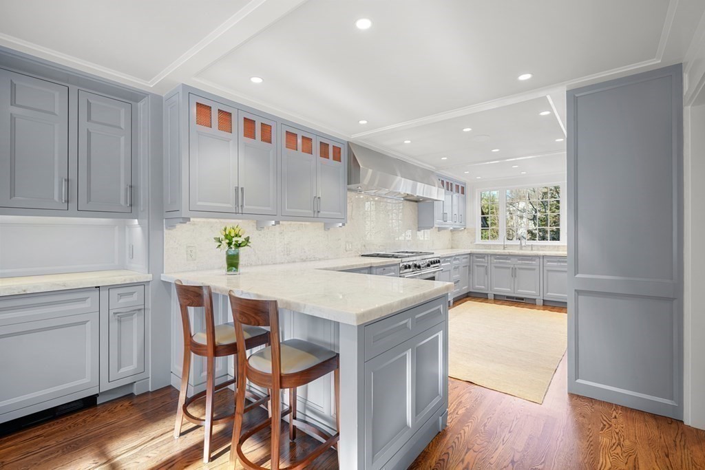 89 Ledgeways Wellesley, MA 02481 - Photo 12 of 42 a kitchen with a stove a refrigerator and a dining table with wooden floor