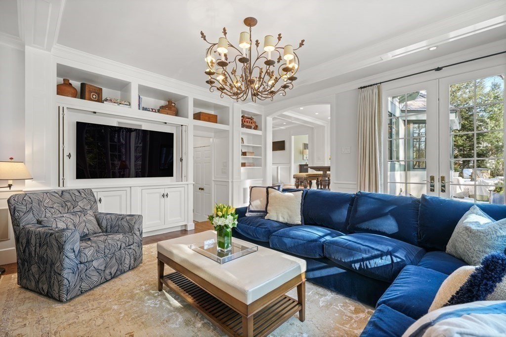 89 Ledgeways Wellesley, MA 02481 - Photo 17 of 42 a living room with furniture a flat screen tv and a chandelier