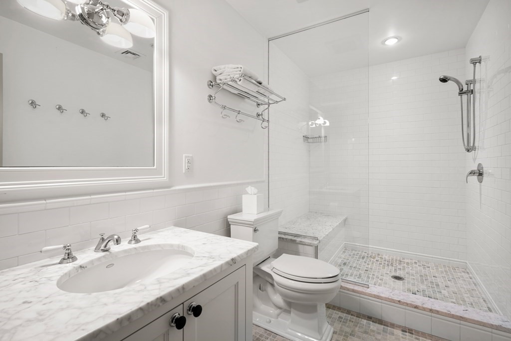 89 Ledgeways Wellesley, MA 02481 - Photo 37 of 42 a bathroom with a sink a toilet and shower