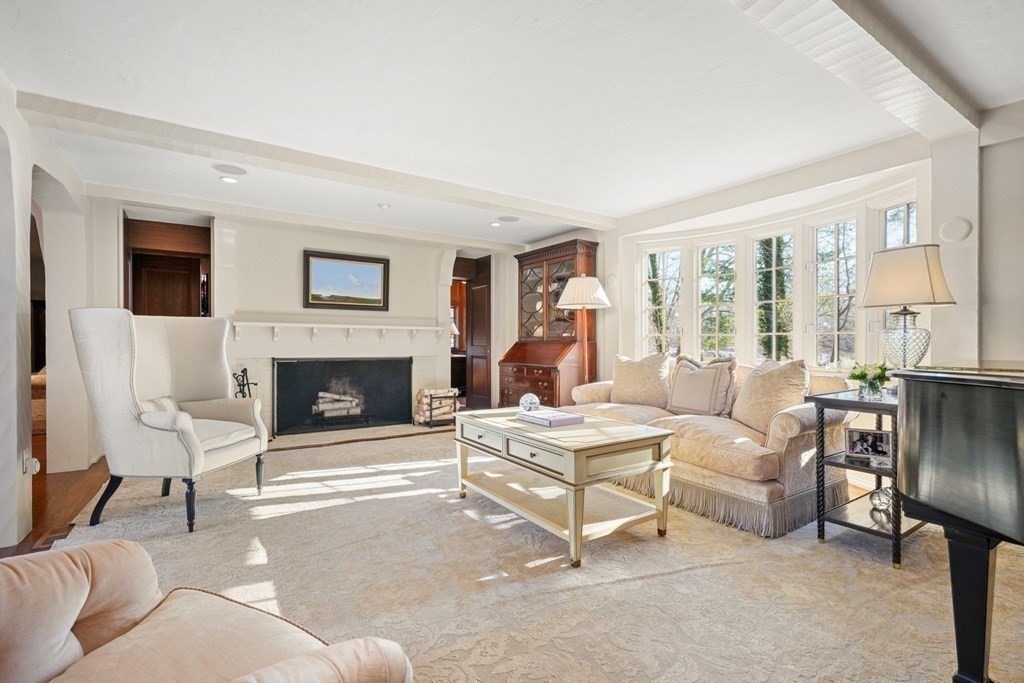 89 Ledgeways Wellesley, MA 02481 - Photo 9 of 42 a living room with furniture a fireplace and a large window