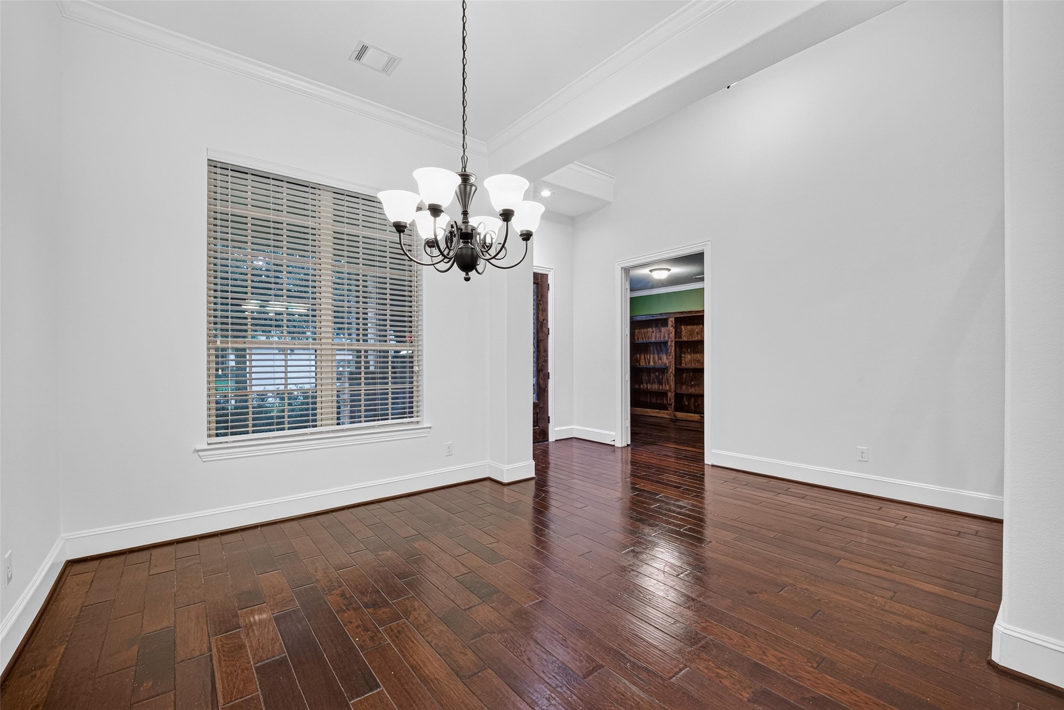 7930 Summer Night Lane Rosenberg, TX 77469 - Photo 8 of 48 Elegant formal dining room with crown molding, and a stylish chandelier.