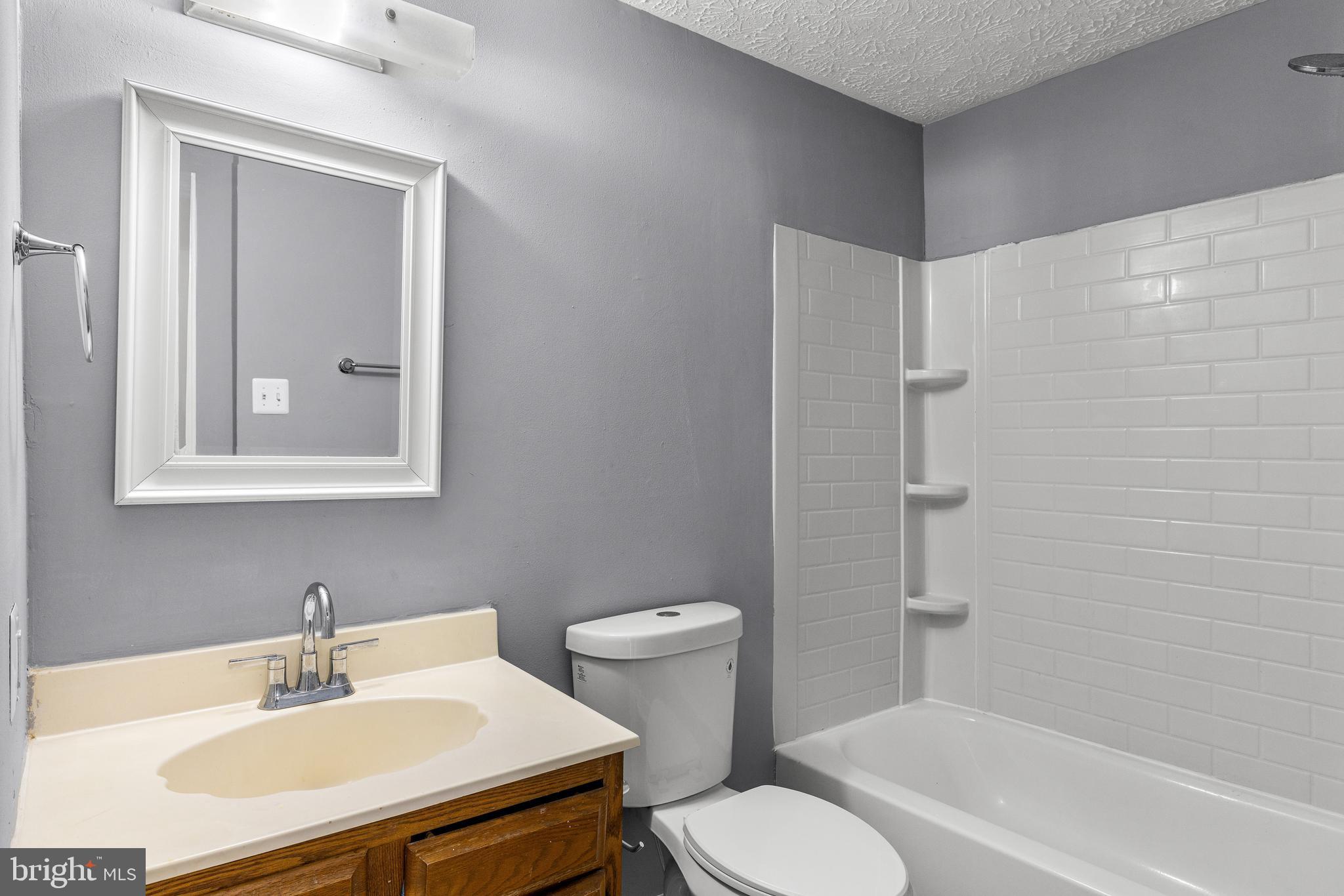 9479 Inaugural Drive King George, VA 22485 - Photo 20 of 26 a bathroom with a sink toilet and shower