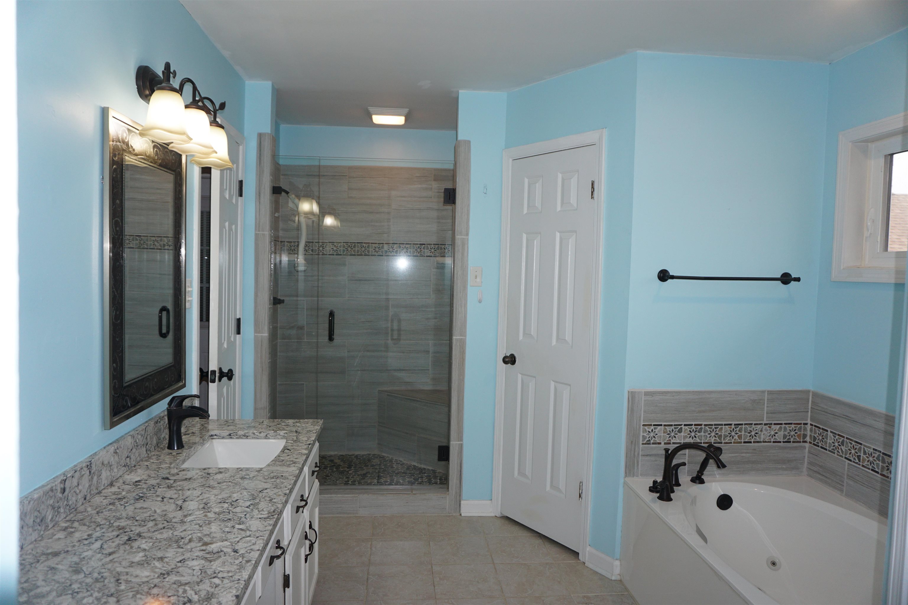 6320 Yale Road Bartlett, TN 38134 - Photo 7 of 25 a bathroom with a granite countertop sink and a mirror