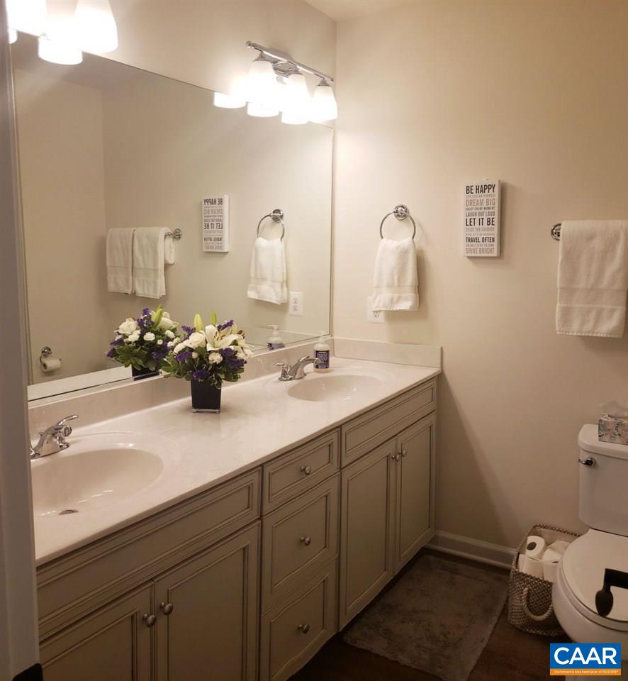 2180 Avinity Loop Charlottesville, VA 22902 - Photo 16 of 32 a bathroom with a sink a toilet and mirror