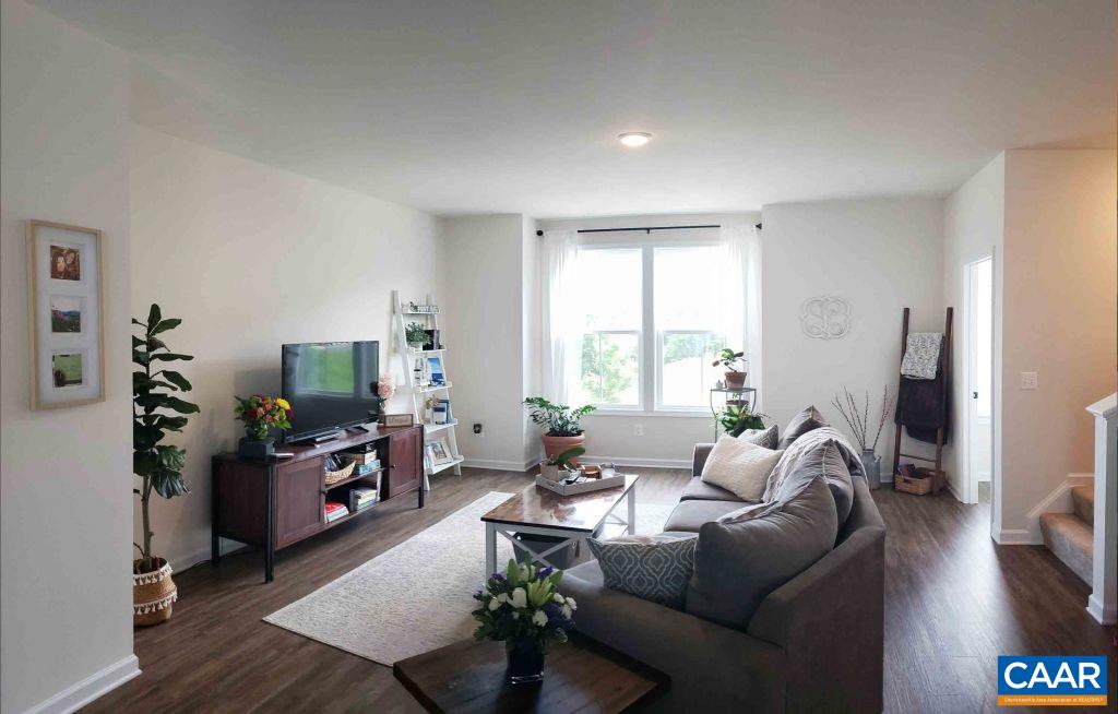 2180 Avinity Loop Charlottesville, VA 22902 - Photo 8 of 32 a living room with furniture a flat screen tv and a large window